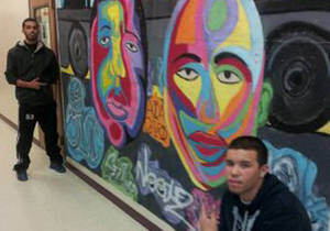 Two artistic students, Magdiel S. and Luis N. from Camden Academy Charter High School, display their painting of hip-hop lends in the main hallway for all to see.