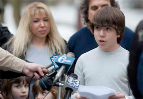 Harriton High School sophomore Blake Robbins reads his account during a news conference outside his Penn Valley home. Behind him are his parents. His siblings Chase and Austin are behind the microphones. (Ed Hille / Staff Photographer)