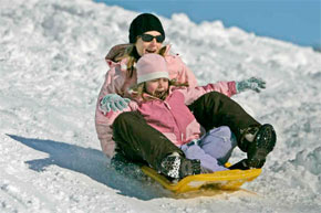 Whitest ever? A coming storm could put us over the top. Above, Claire Rankin and her mother, Jen, take a slide in Wallingford. (Michael Bryant / Staff Photographer)