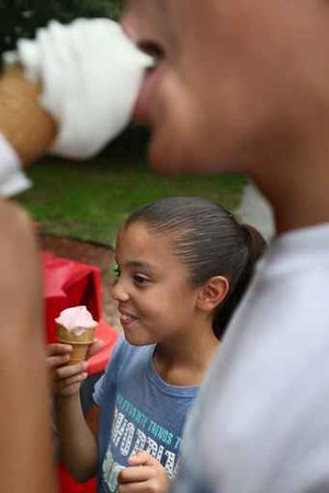 Deborah Martinez, 9 and her brother (foreground)   Jacob, 13, shown enjoying soft ice cream at Mister Softee on Haddonfield Rd., Pennsauken.  (David M Warren / Inquirer)  