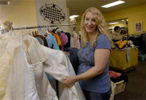 At the Junior League Thrift Shop in Ardmore, Sherrie Jenkins checks out the wedding gowns. (April Saul / Staff Photographer)