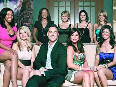 Matchmakers Steve Ward and his mother, JoAnn, surrounded by a bevy of beauties in the second season of &acute;Tough Love.&acute;