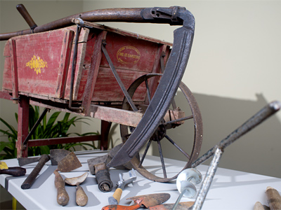 Scythe and early 19th-century wheelbarrow. Sweetman is fond of his grandfather&acute;s scythe, with elegant, bowed blade and crooked shaft. The shiny patina on the hickory handle evolved over decades of sweaty use. (Ed Hille / Staff Photographer)