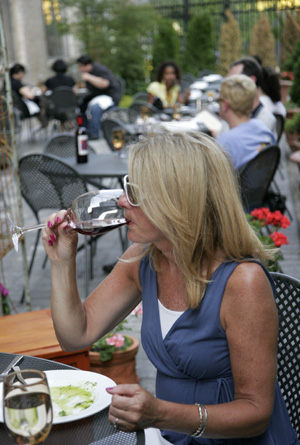 Taking a sipping of wine is Susan Gallagher, who was dining with her husband and another couple at Osteria on North Broad Street.
