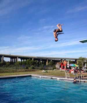 Veronica Yankanich wasn&acute;t far from her Collingswood home when she captured her 11-year-old son Joe doing a front flip off the high dive. They were spending the day July 25 with friends at the Gloucester City Swim Club, where the Walt Whitman Bridge is in the background.